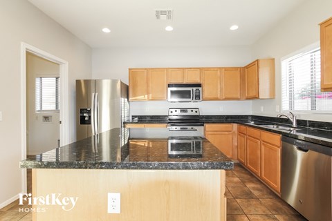 A kitchen with wooden cabinets and stainless steel appliances.