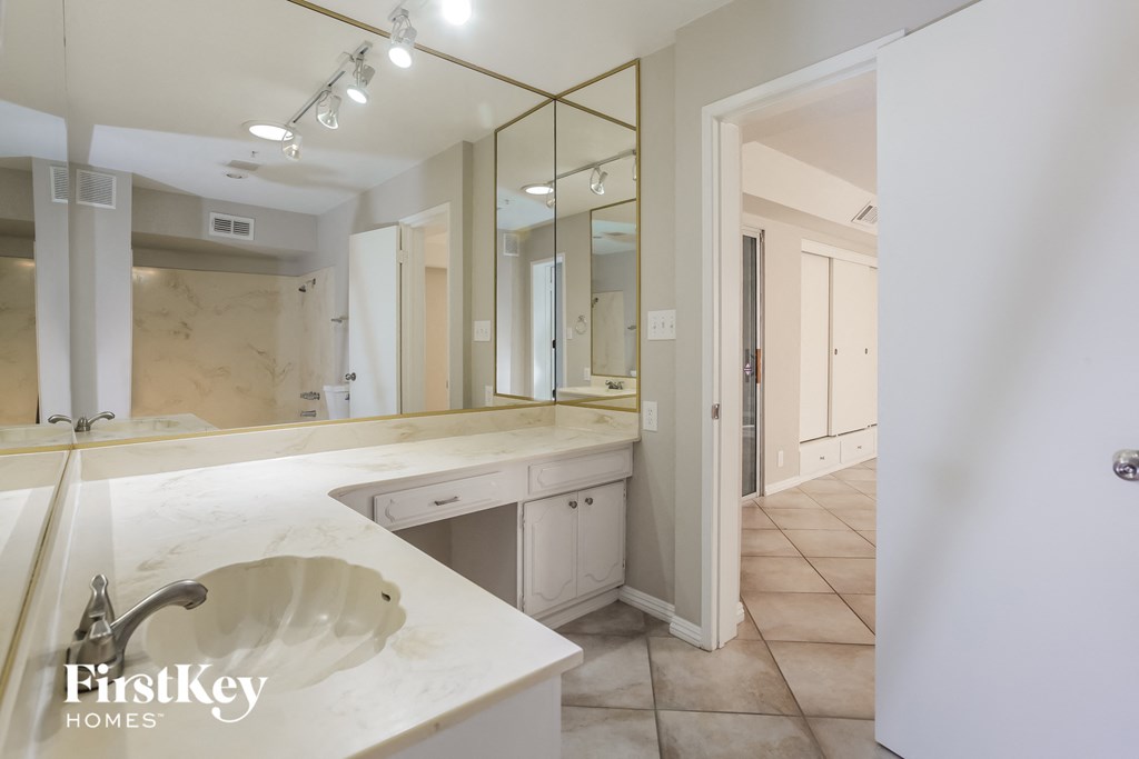 a large bathroom with a large mirror and a sink