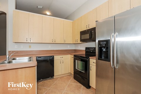a kitchen with stainless steel appliances and wooden cabinets