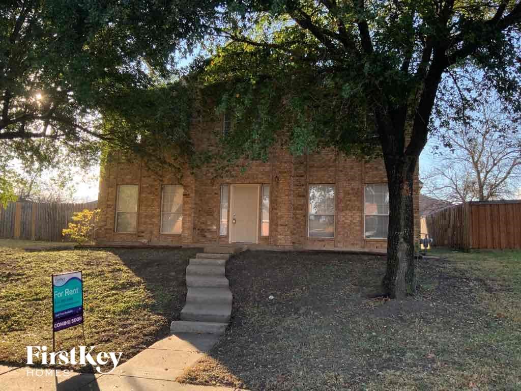a brick house with a tree in front of it