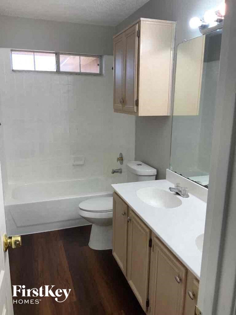 a bathroom with a sink toilet and a bath tub