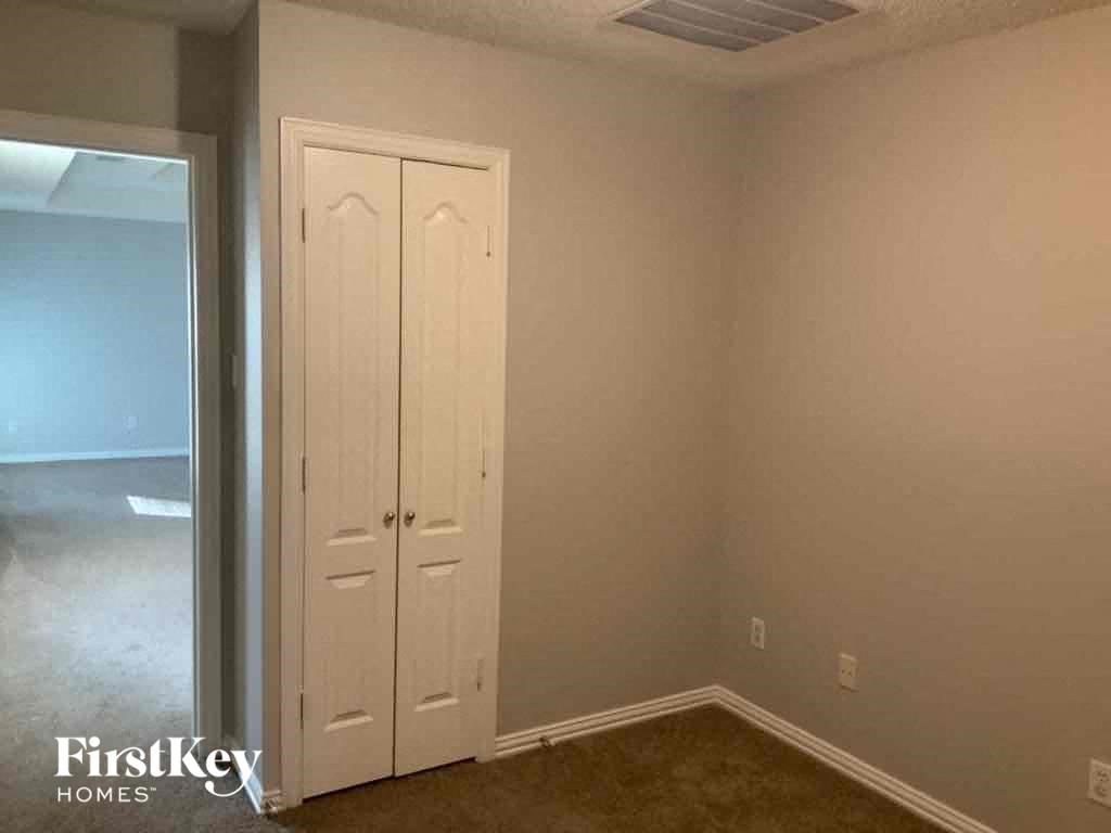 a room with a closet and a mirror in it