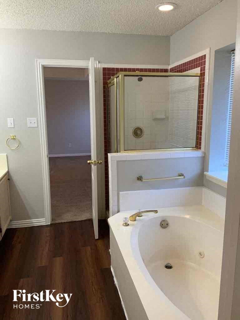 a bathroom with a sink and a shower and a mirror