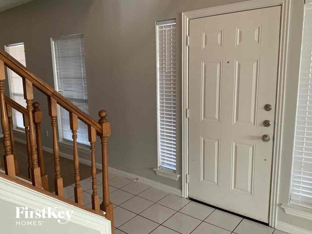 the landing of a staircase in a home with a white door