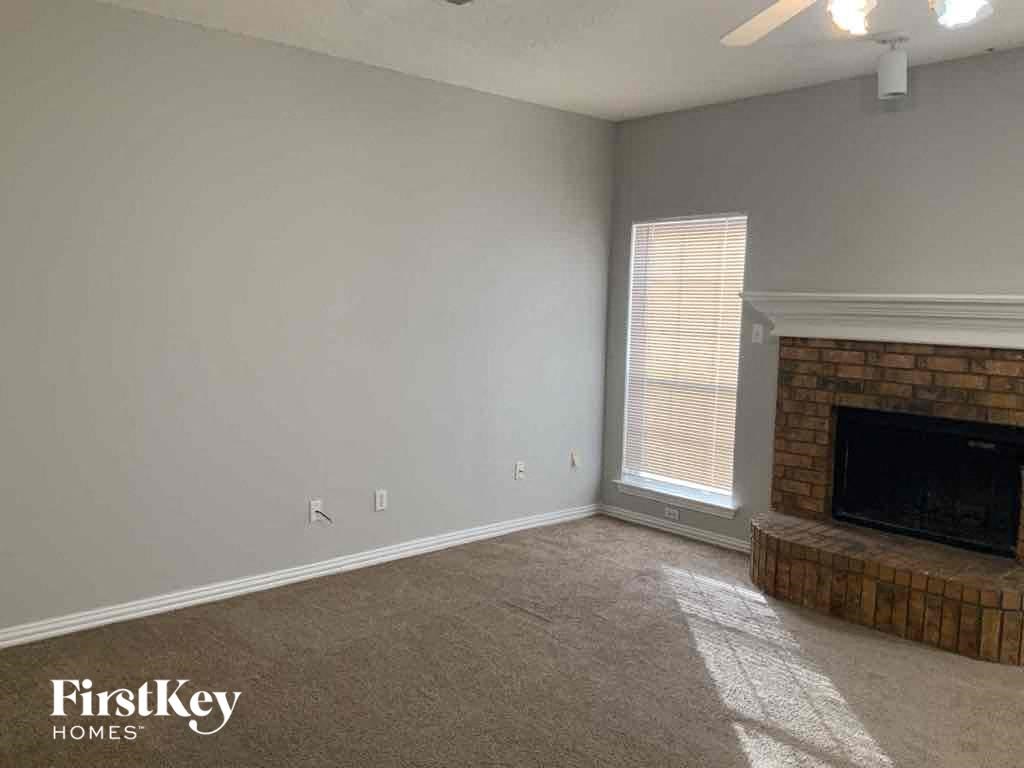 a living room with a fireplace and a window