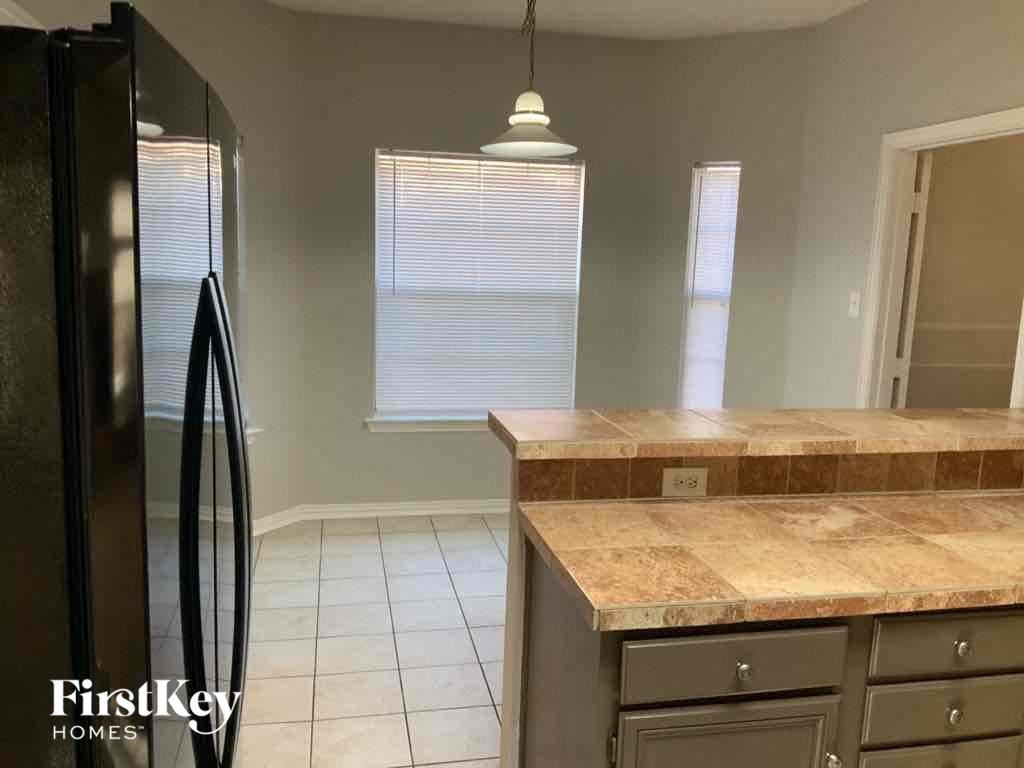 a kitchen with a counter top and a refrigerator