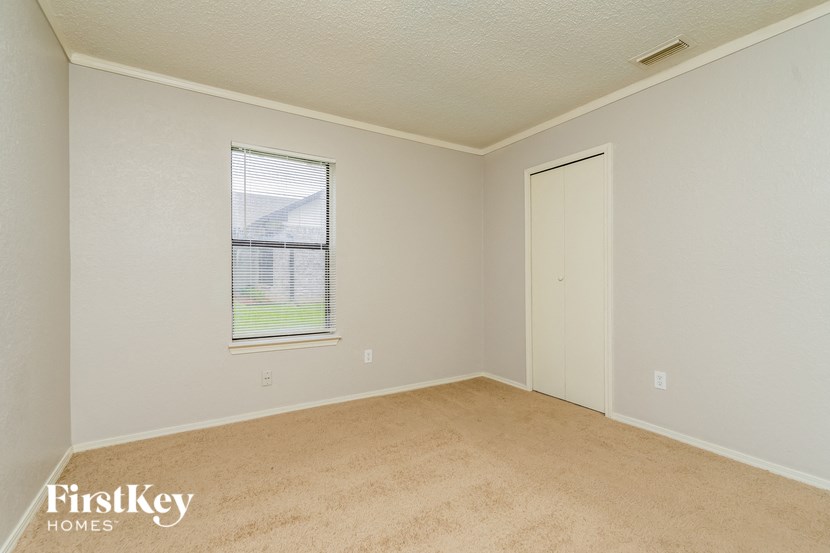 the living room of an empty house with a window and a door