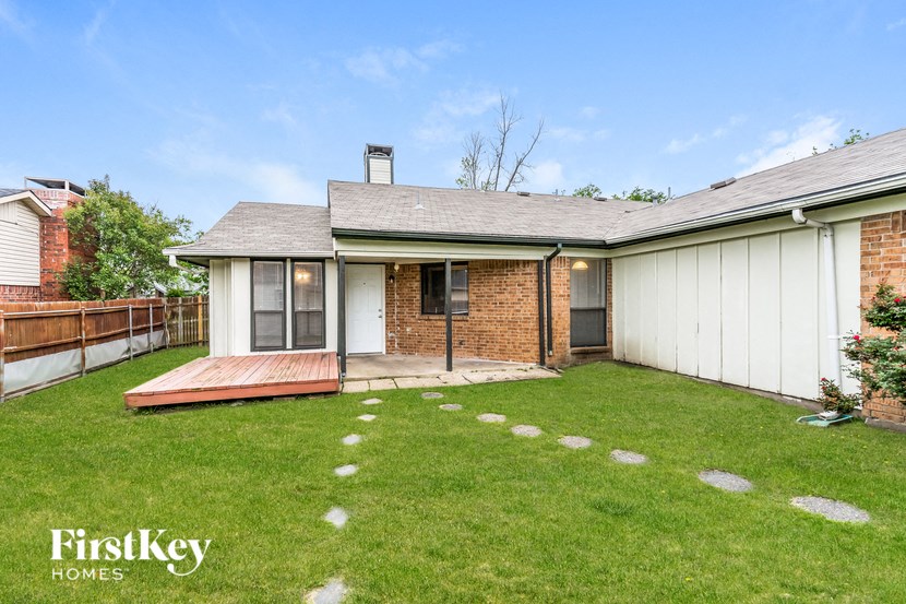 a house with a grass yard and a deck
