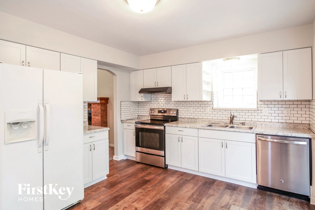 A kitchen with white cabinets and a stainless steel dishwasher.