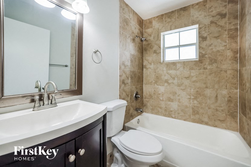 a bathroom with a sink toilet and a bath tub