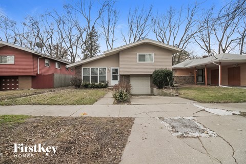 a house with a sidewalk and a driveway in front of it