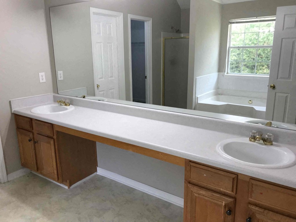 a bathroom with two sinks and a large mirror