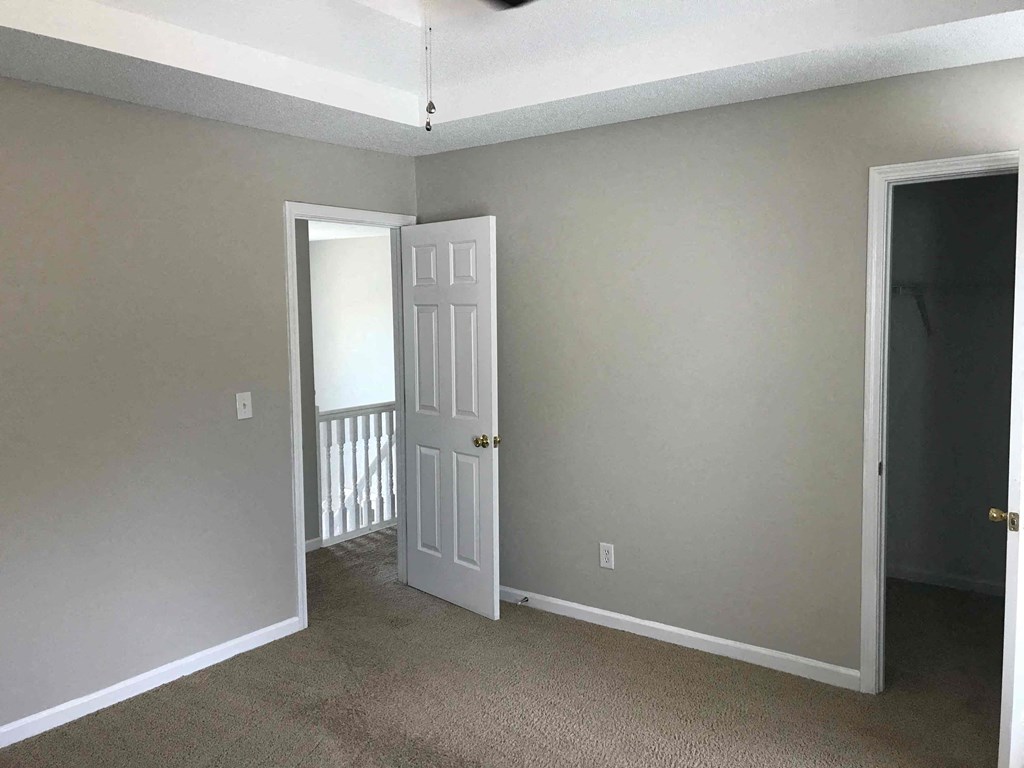 a living room with a door to a balcony