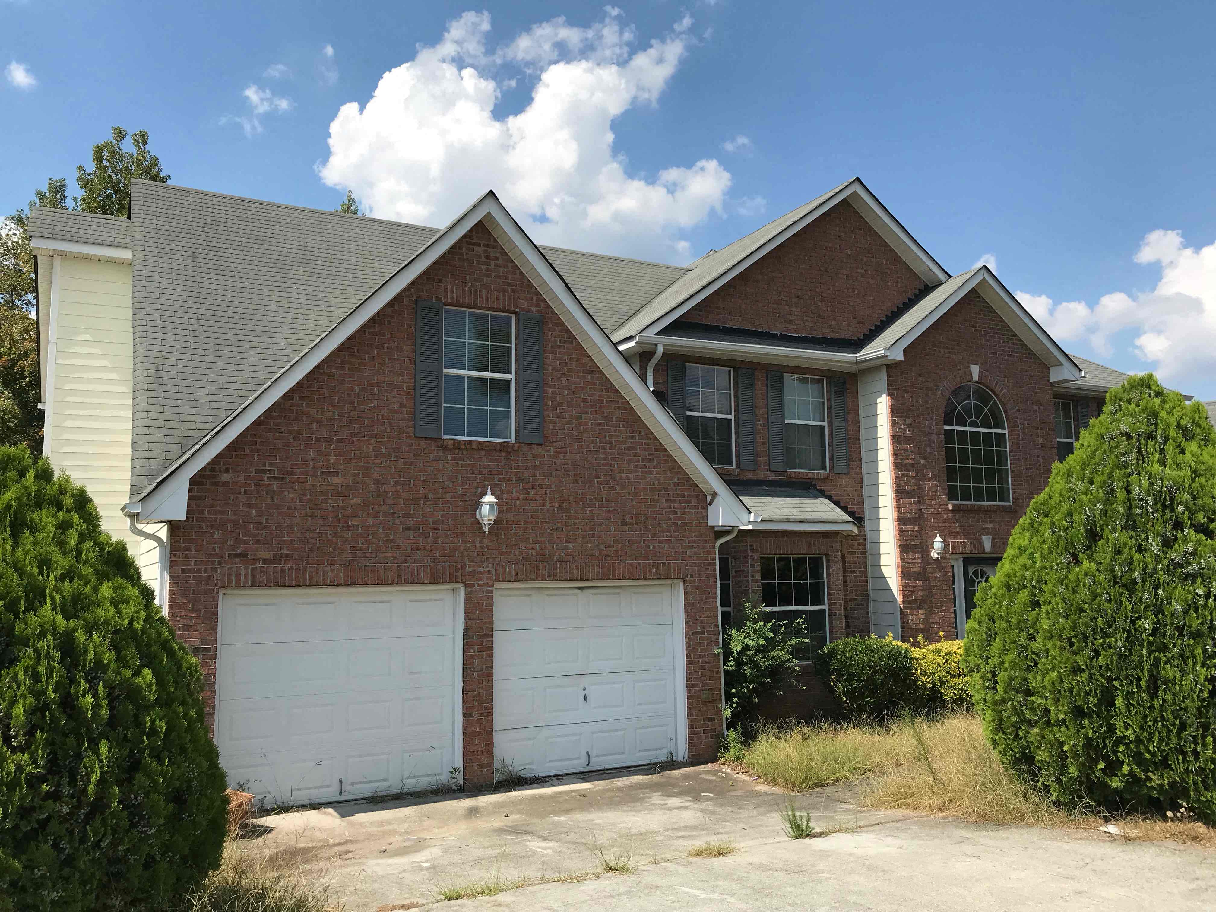 a house with two garage doors in front of it