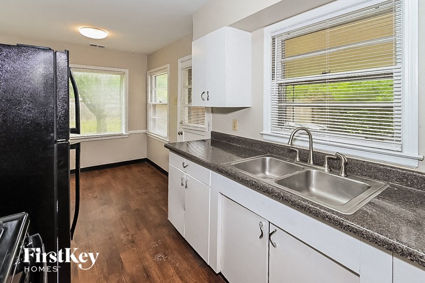 a kitchen with a sink and a refrigerator