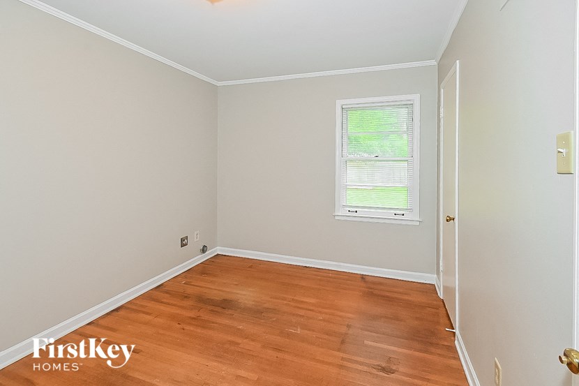 a empty room with wooden floors and a window