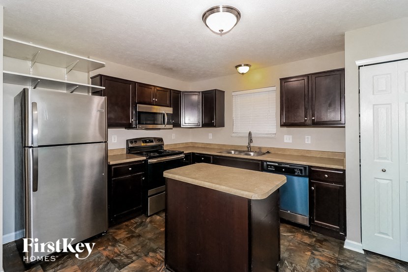 a kitchen with stainless steel appliances and wooden cabinets
