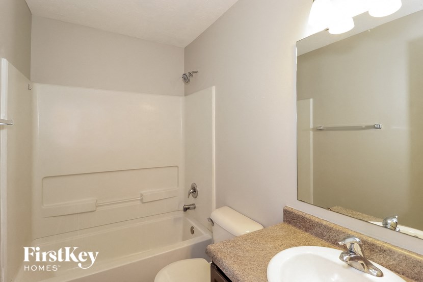 a bathroom with a sink and a bath tub and a mirror