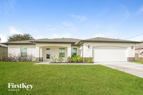 a house with a lawn and a garage door