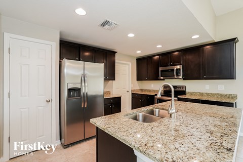 a kitchen with granite counter tops and stainless steel appliances