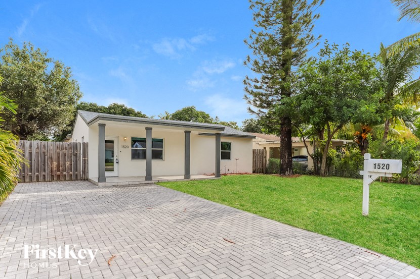 A house with a driveway and a sign that says 1520.