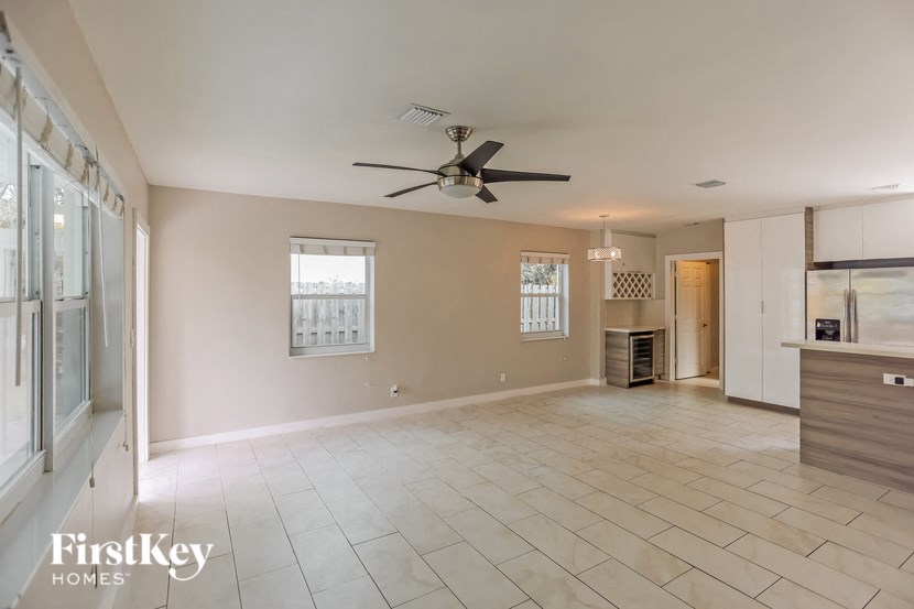 A spacious room with a ceiling fan and a window.
