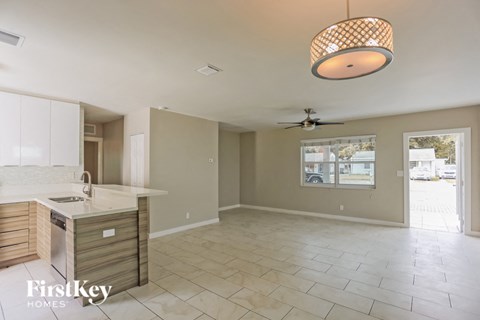 A kitchen with a counter and a fridge.