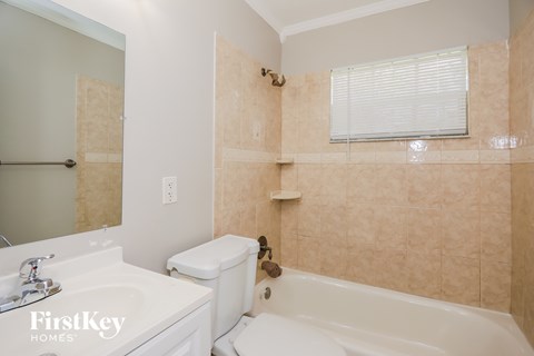 a bathroom with a sink toilet and a bath tub