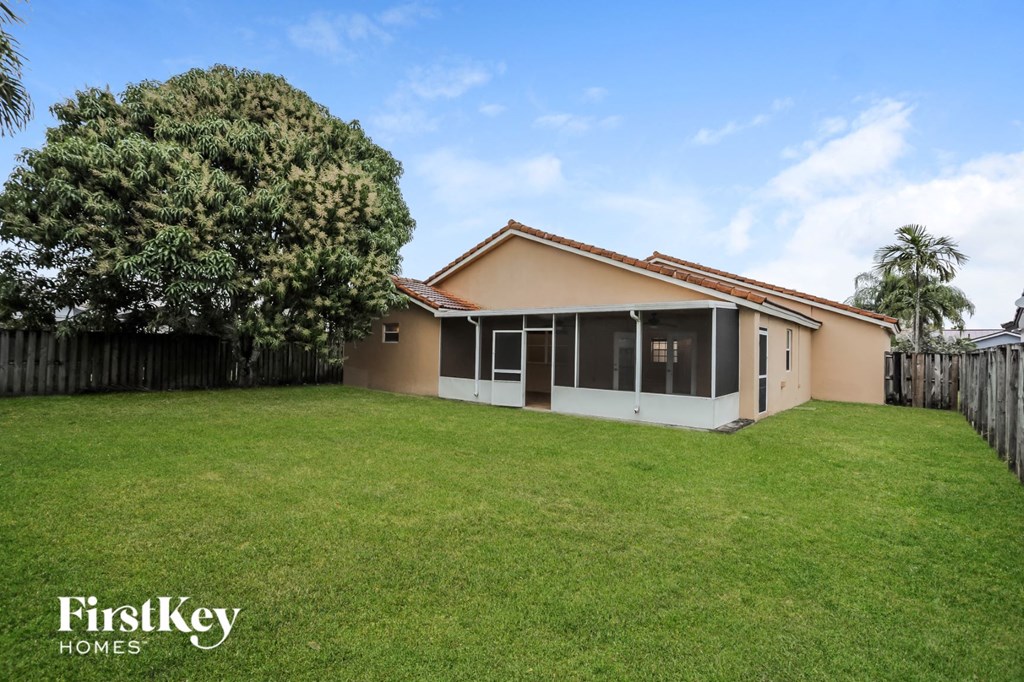 a backyard with a lawn and a house