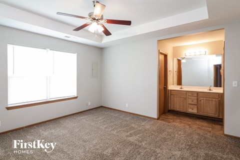 the master bedroom has a large window and a large vanity