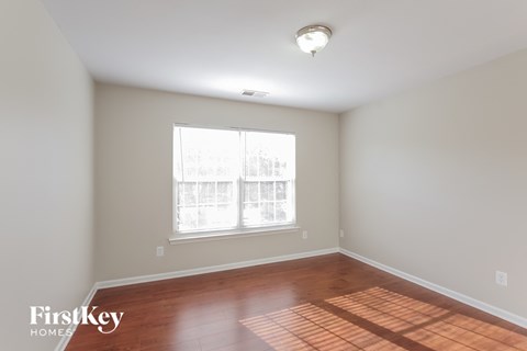 a living room with wood floors and a large window