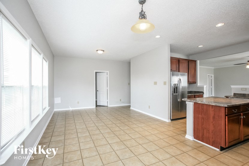 a kitchen and living room with a large window