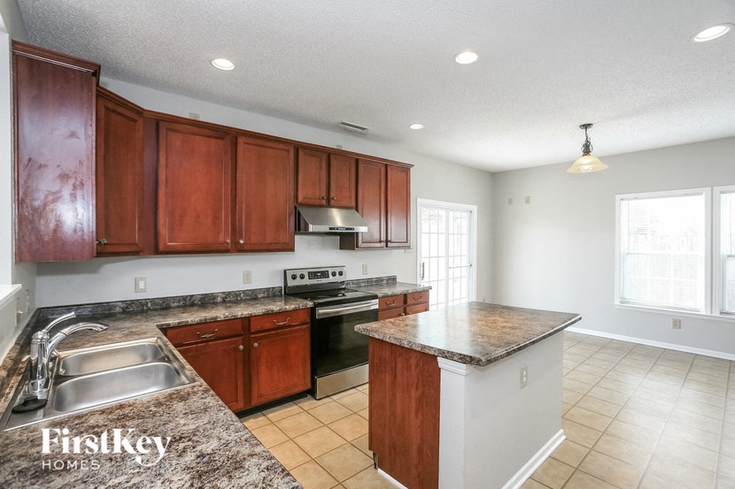 a kitchen with wooden cabinets and stainless steel appliances