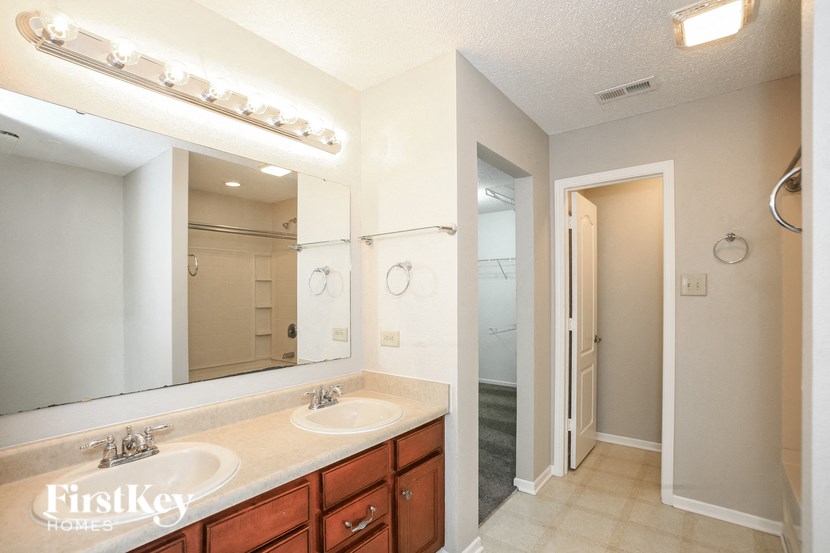 a bathroom with two sinks and a large mirror
