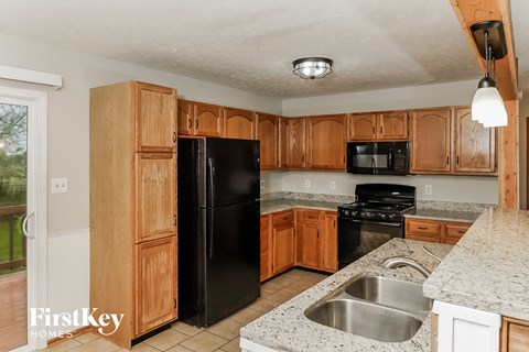 a kitchen with black appliances and wooden cabinets