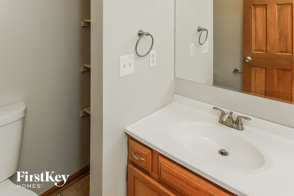 a bathroom with a sink and a mirror and a toilet