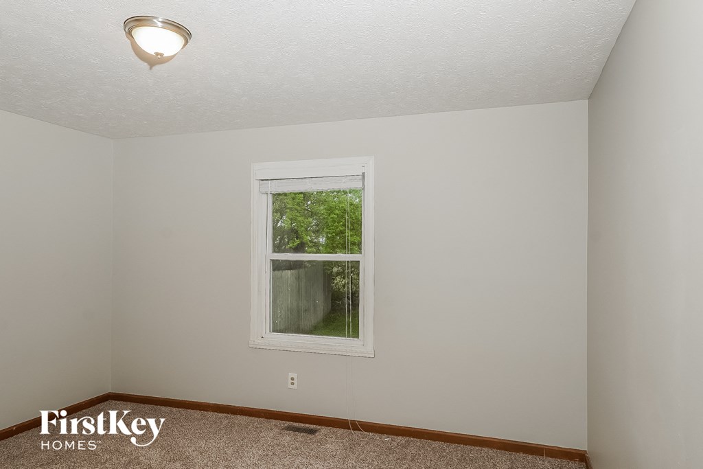 the living room of a small white house with a window