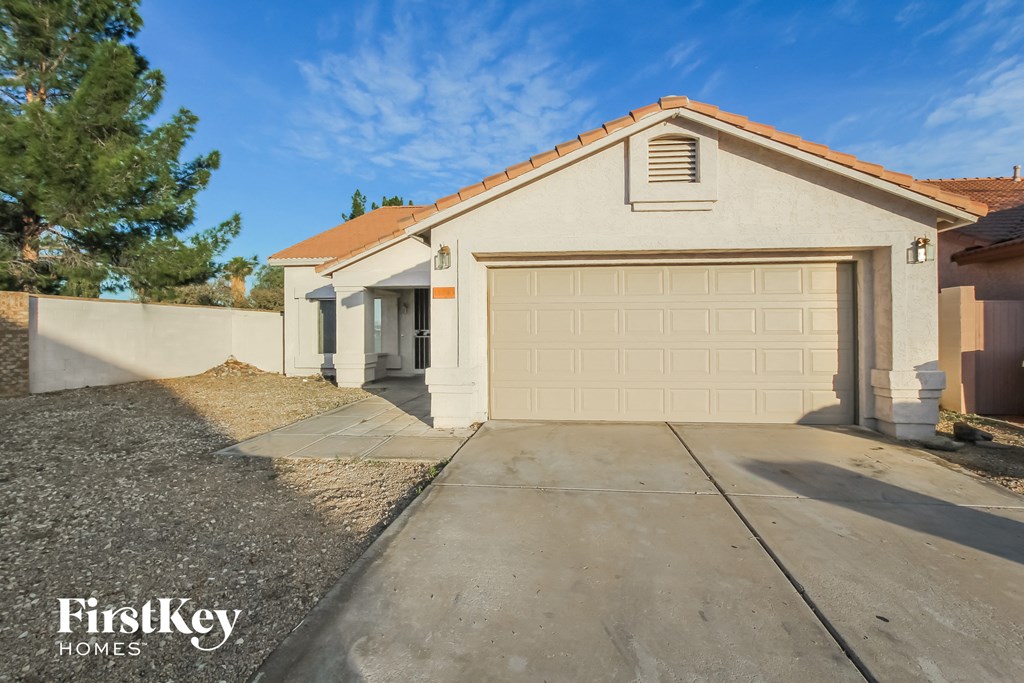 a home with a white garage door and a driveway