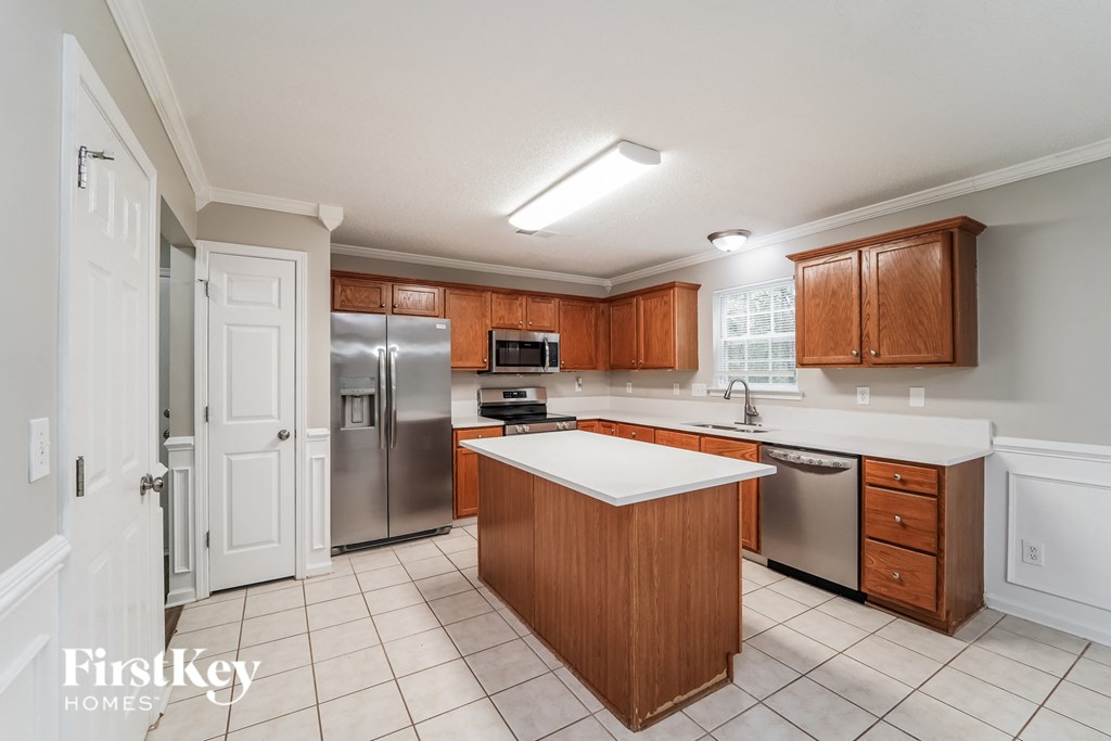 a kitchen with wooden cabinets and stainless steel appliances