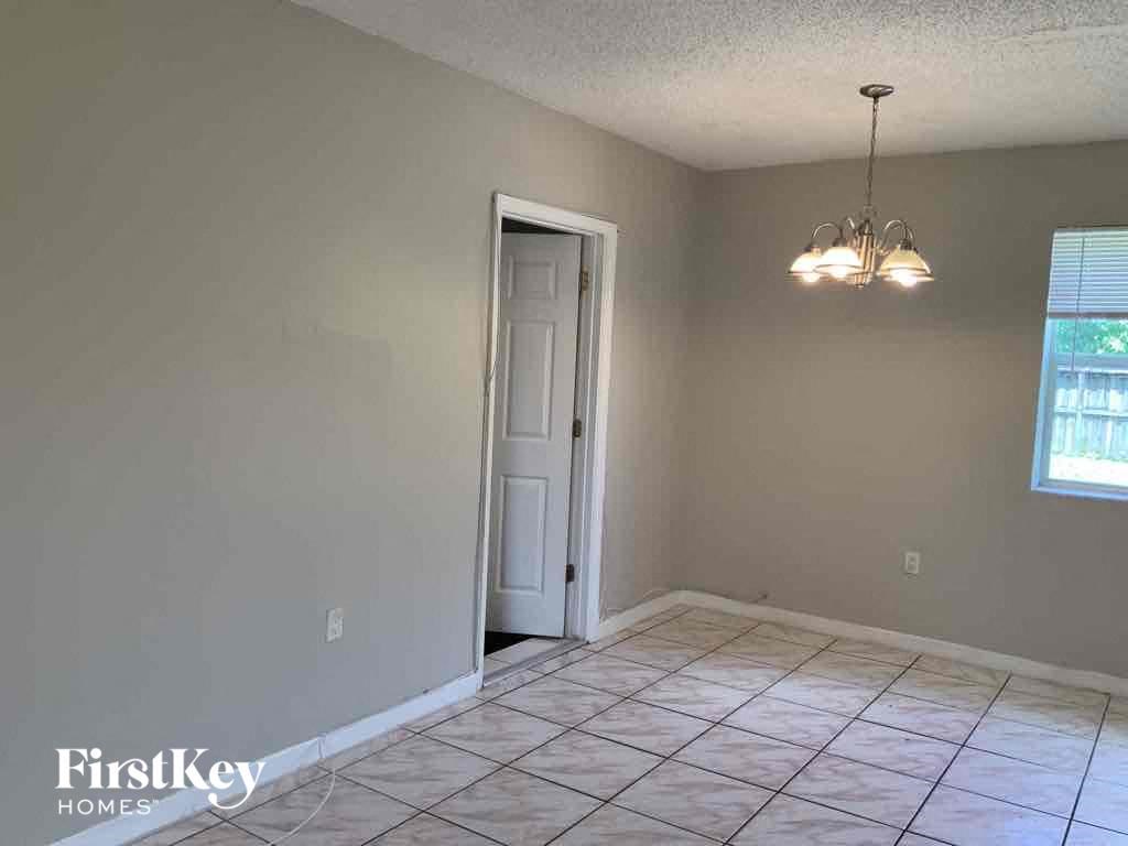 A room with a door and a chandelier.