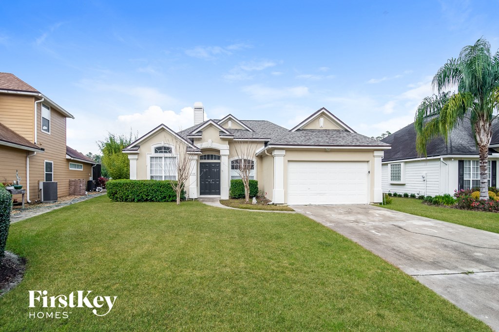A house with a well-maintained lawn and a clear sky above.