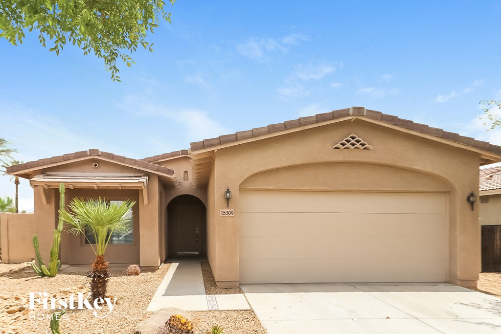 A house with a garage and a driveway.