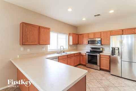 A kitchen with wooden cabinets and stainless steel appliances.