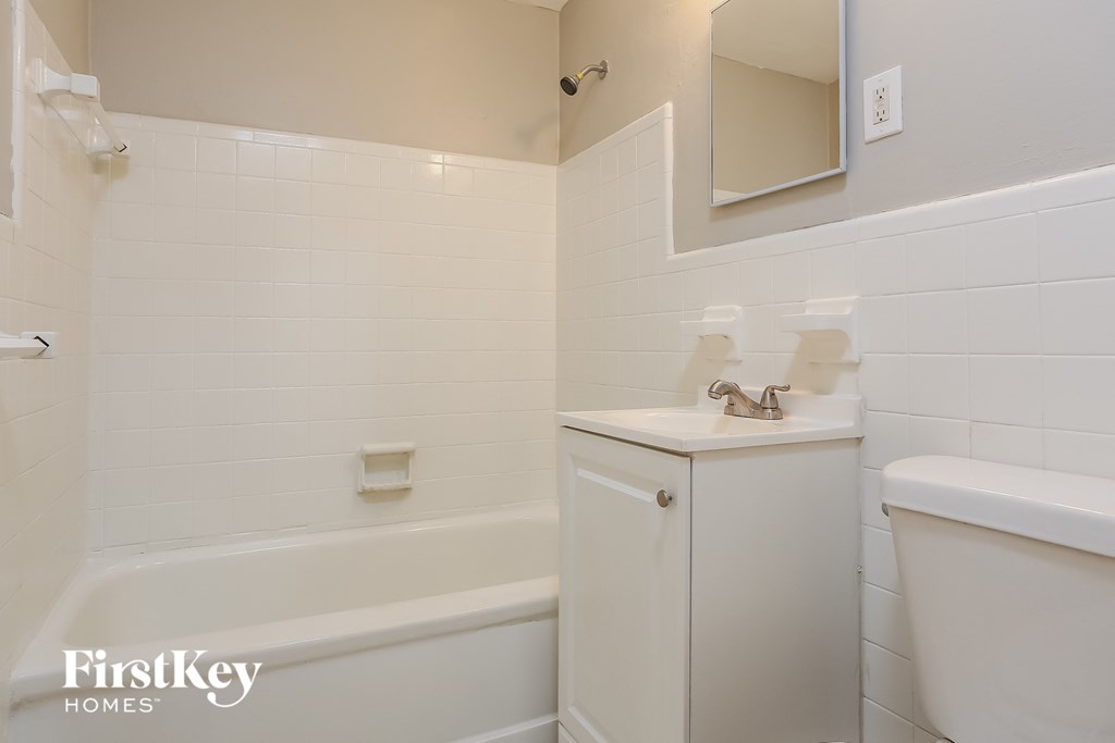 a white bathroom with a toilet sink and tub
