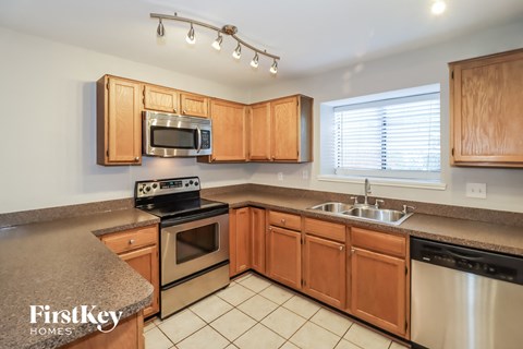 a kitchen with wooden cabinets and stainless steel appliances