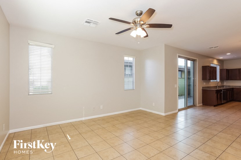 a empty living room with a ceiling fan
