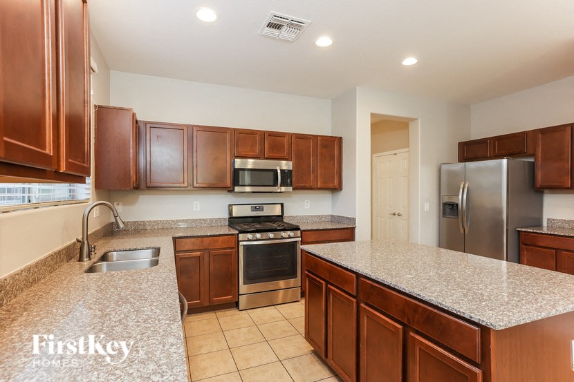 a kitchen with granite counter tops and stainless steel appliances