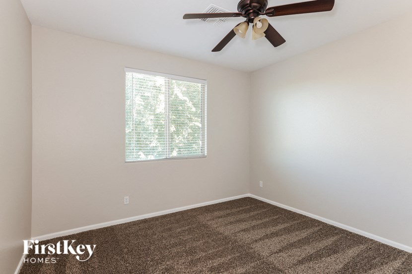 the living room of a home with a ceiling fan