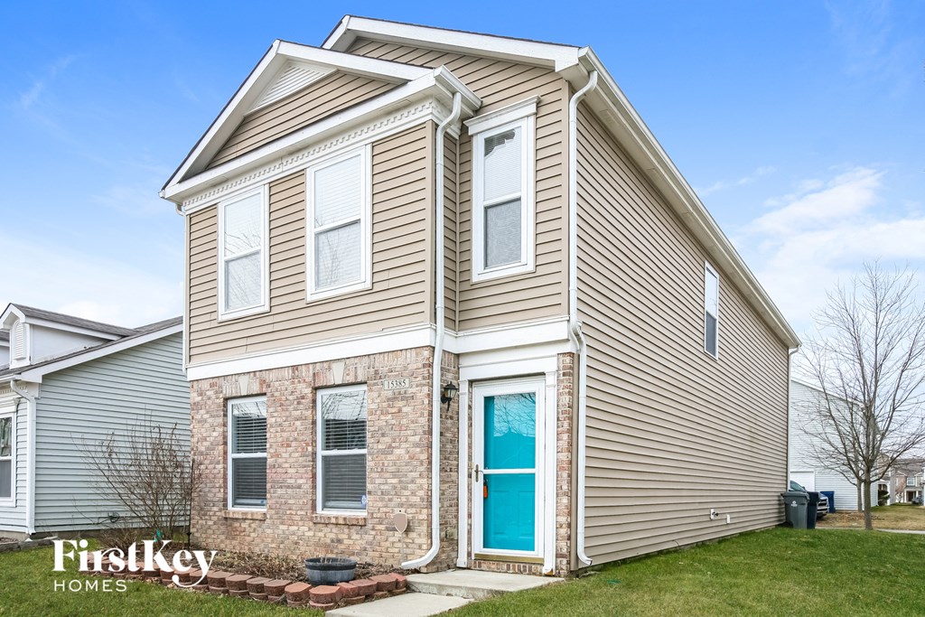 the front of a house with a blue door