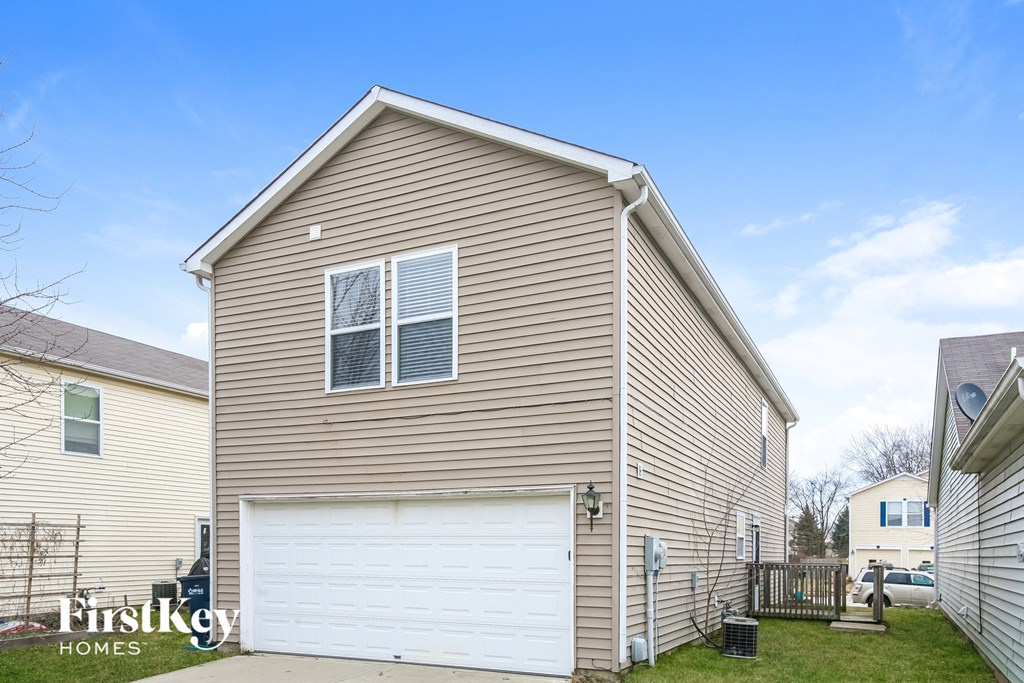 the outside of a house with a white garage door